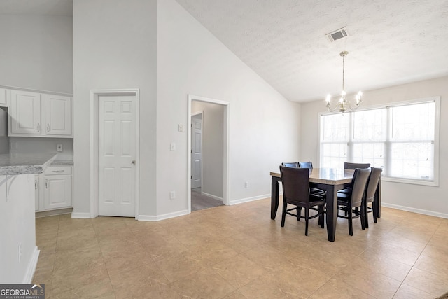 dining space featuring high vaulted ceiling, light tile patterned floors, a textured ceiling, and a notable chandelier