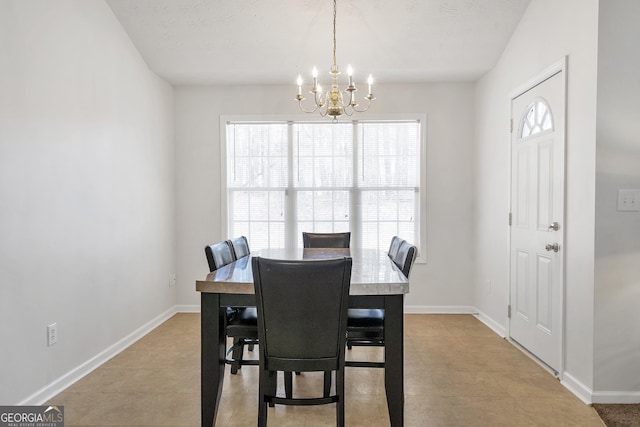 dining area featuring an inviting chandelier and light tile patterned flooring