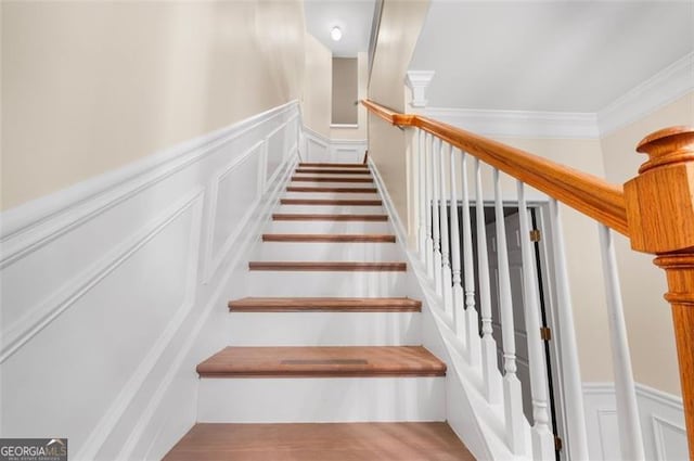 staircase featuring crown molding