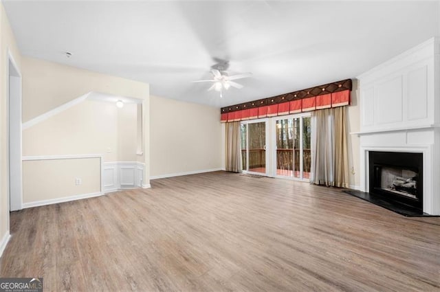 unfurnished living room featuring ceiling fan and light hardwood / wood-style floors