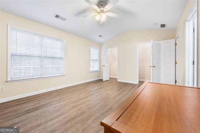 unfurnished bedroom with hardwood / wood-style floors, vaulted ceiling, and ceiling fan