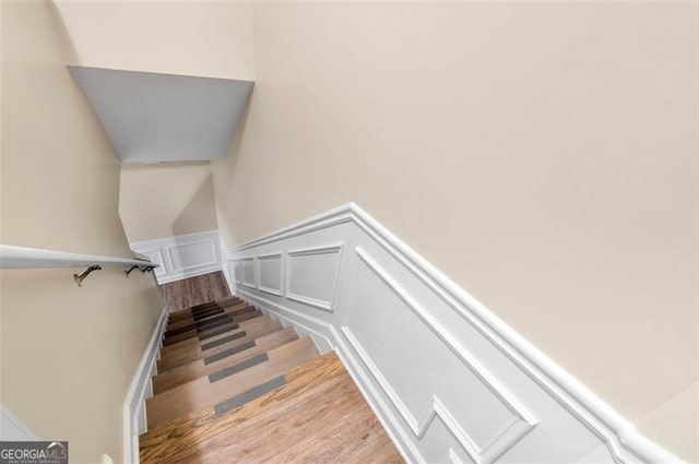 stairs with hardwood / wood-style floors