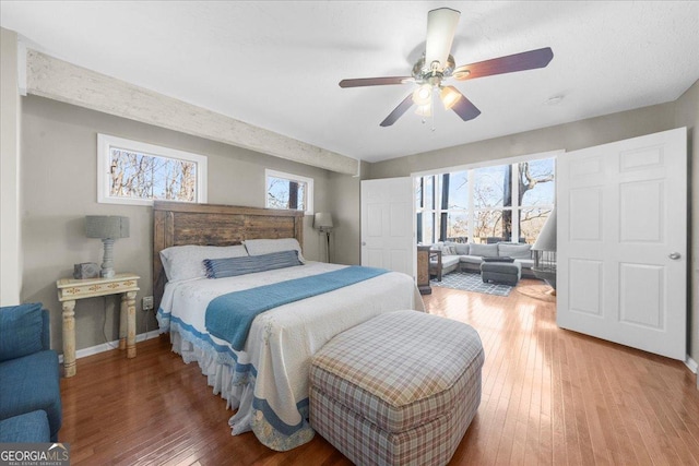 bedroom with ceiling fan and hardwood / wood-style floors