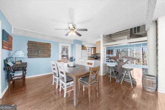 dining area featuring wood-type flooring and ceiling fan