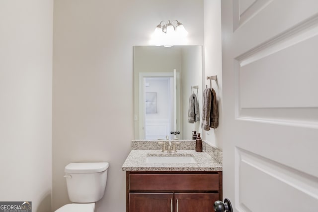 bathroom with toilet and vanity