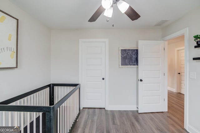 unfurnished bedroom featuring hardwood / wood-style flooring and ceiling fan