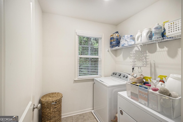 laundry room featuring light tile patterned flooring and washing machine and clothes dryer