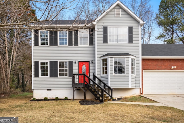 view of front of house with a garage and a front lawn