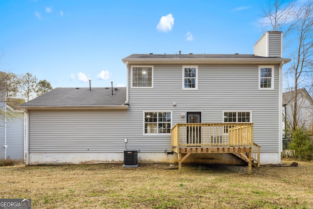 rear view of house with a wooden deck, central air condition unit, and a lawn