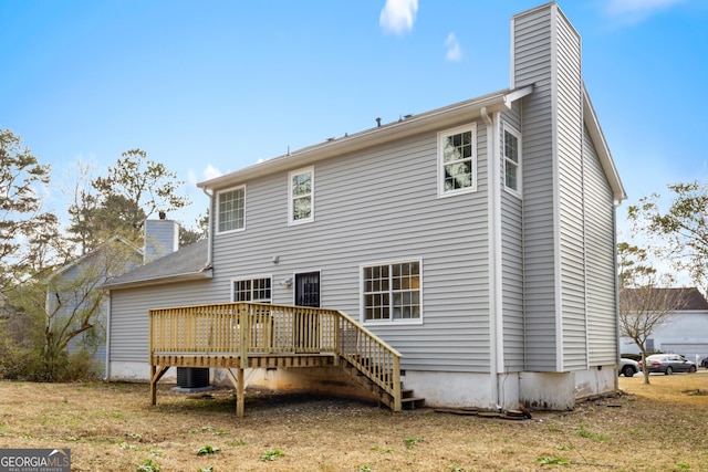 rear view of property with central AC unit and a deck