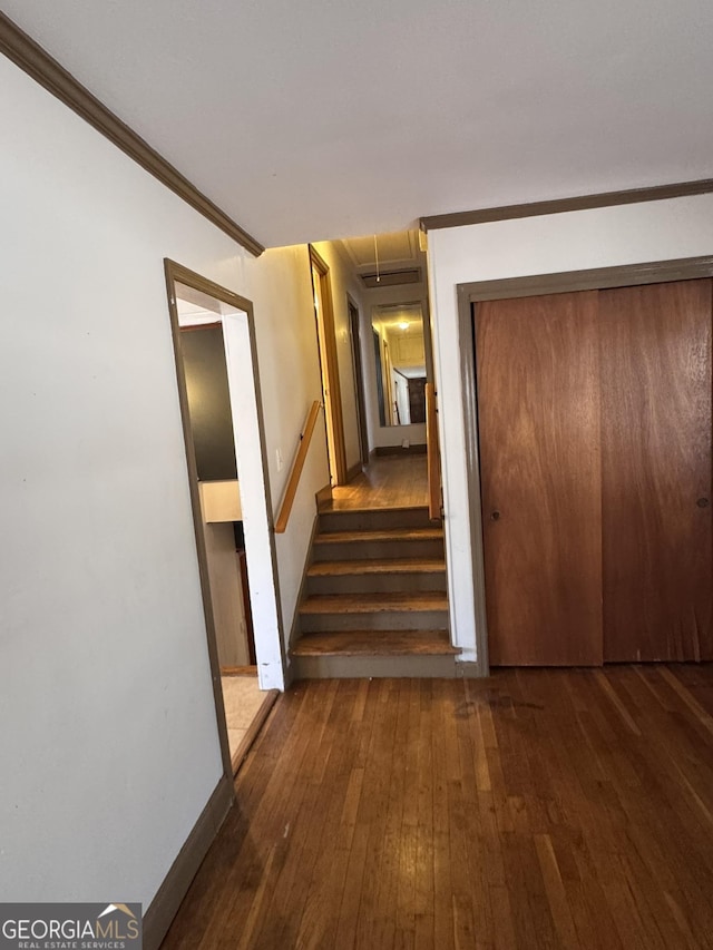 hall with dark hardwood / wood-style flooring and crown molding