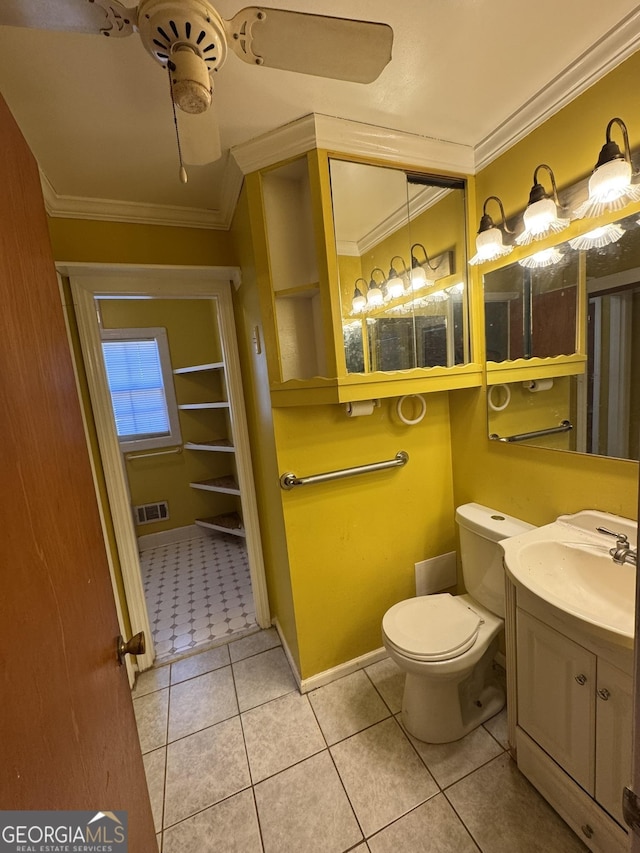 bathroom with crown molding, vanity, toilet, and tile patterned flooring