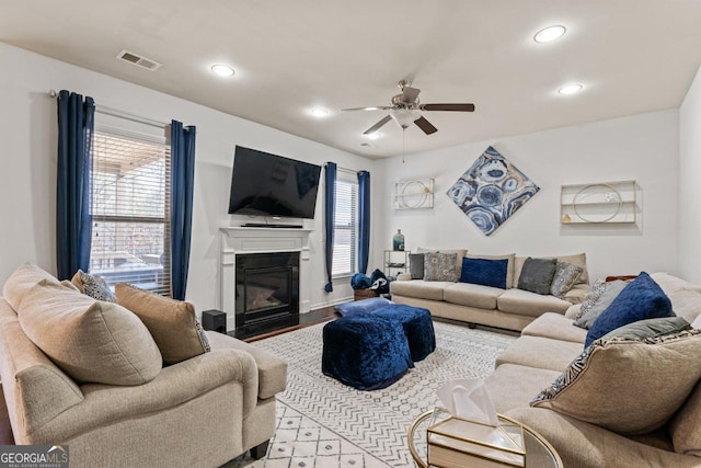 living room featuring ceiling fan and light hardwood / wood-style floors