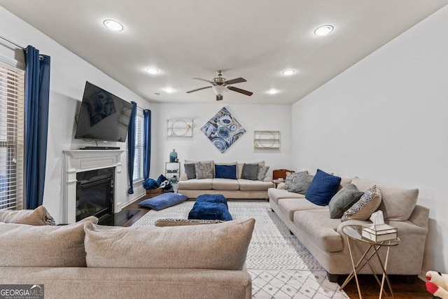 living room with hardwood / wood-style flooring and ceiling fan