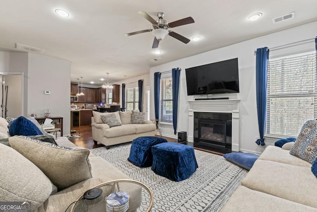 living room with hardwood / wood-style flooring and ceiling fan