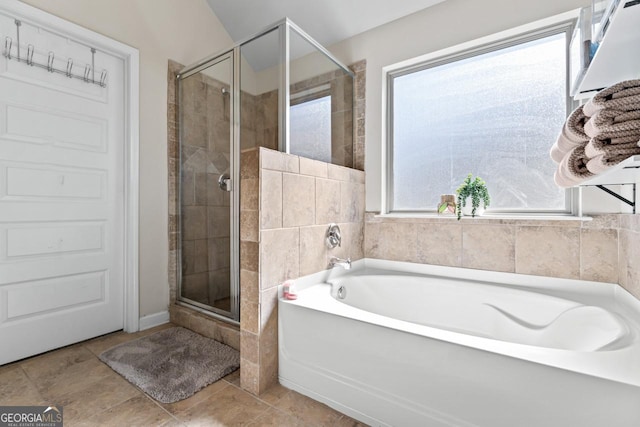 bathroom with tile patterned flooring and shower with separate bathtub