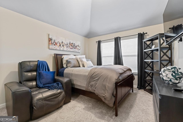 bedroom featuring vaulted ceiling and light carpet