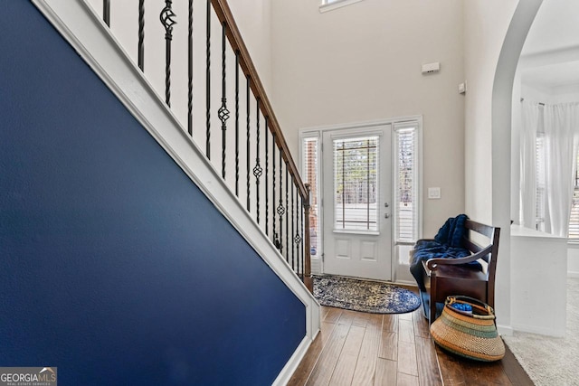 foyer featuring hardwood / wood-style flooring and a high ceiling