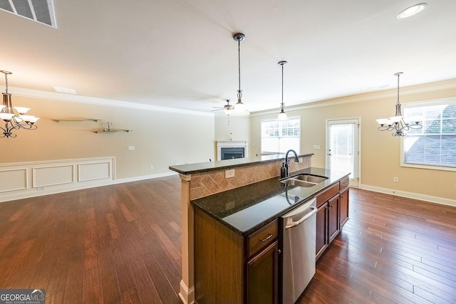 kitchen with stainless steel dishwasher, ornamental molding, sink, and hanging light fixtures