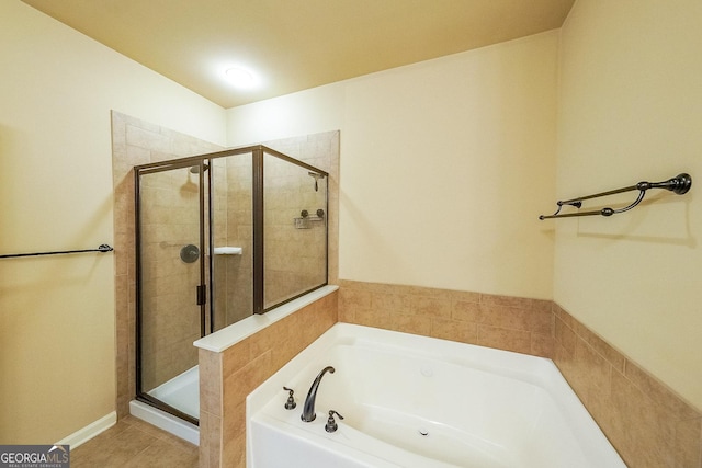 bathroom with independent shower and bath and tile patterned flooring