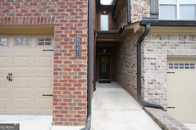 doorway to property with a garage