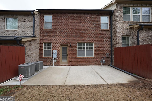 rear view of house featuring central air condition unit and a patio area