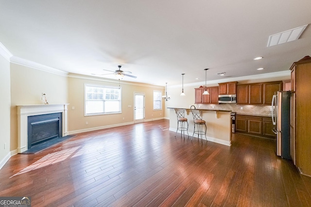 unfurnished living room with crown molding, dark hardwood / wood-style floors, and ceiling fan