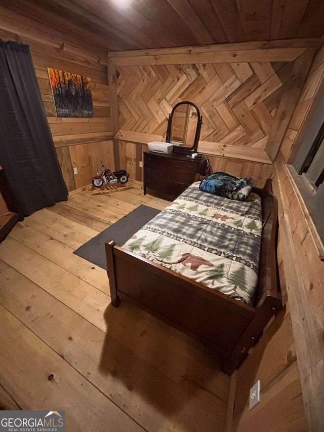 bedroom featuring wooden ceiling, wood-type flooring, and wood walls