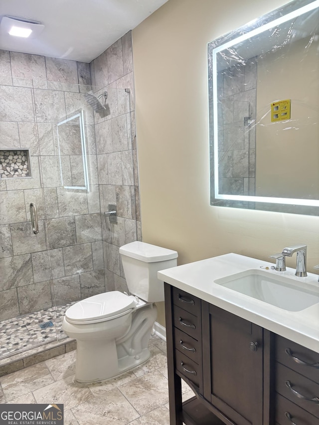 bathroom with vanity, toilet, and walk in shower