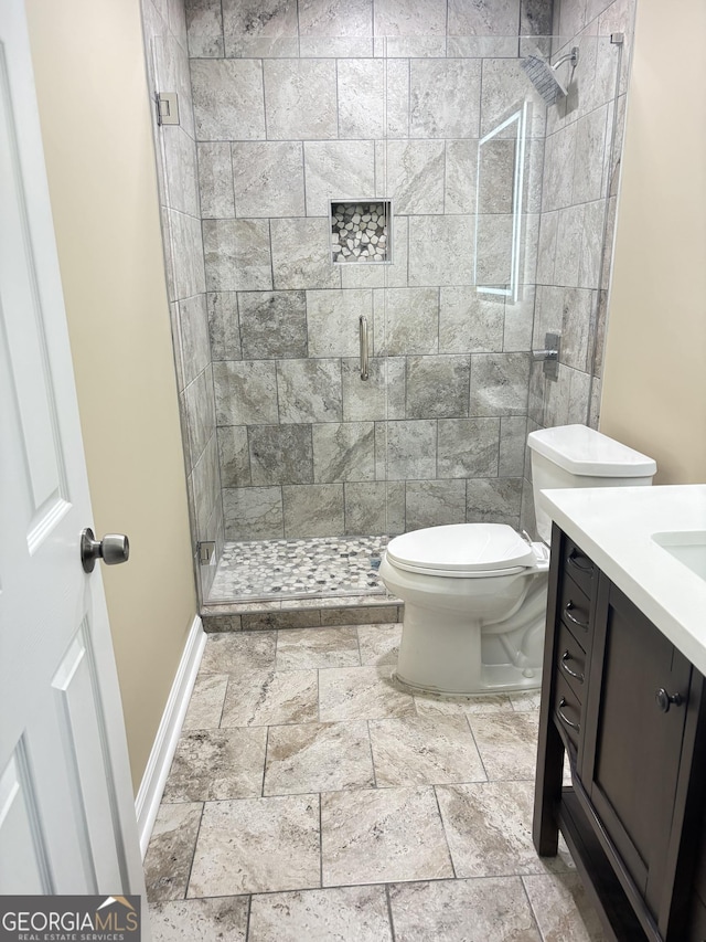 bathroom featuring walk in shower, vanity, and toilet