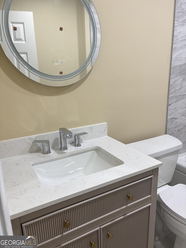 bathroom with vanity and toilet