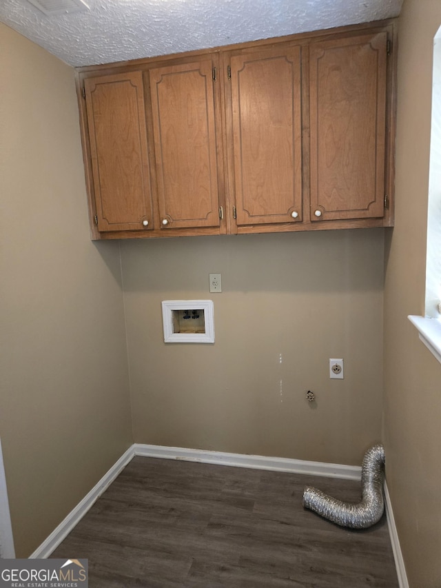 laundry room with dark hardwood / wood-style floors, cabinets, a textured ceiling, and hookup for an electric dryer