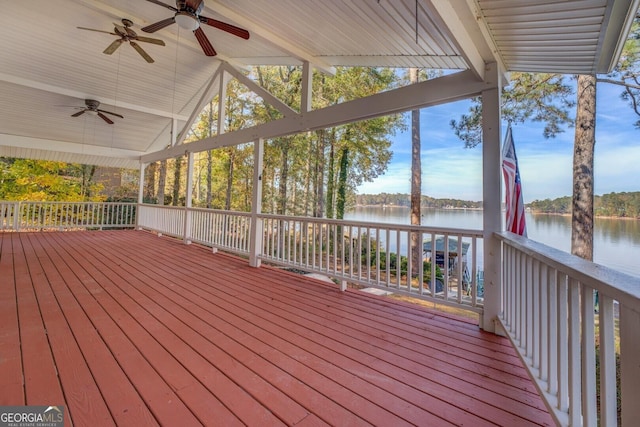 deck with a water view and ceiling fan