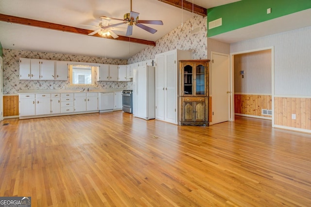 unfurnished living room featuring lofted ceiling with beams, ceiling fan, sink, and light wood-type flooring