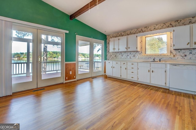 kitchen with white cabinetry, white dishwasher, a wealth of natural light, lofted ceiling with beams, and french doors