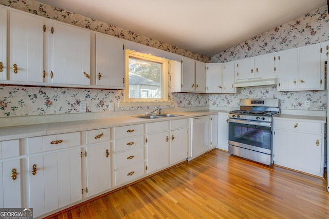 kitchen with sink, gas range, white cabinetry, light hardwood / wood-style flooring, and white dishwasher