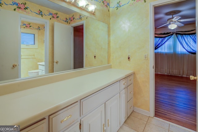 bathroom with ceiling fan, plenty of natural light, tile patterned floors, and toilet