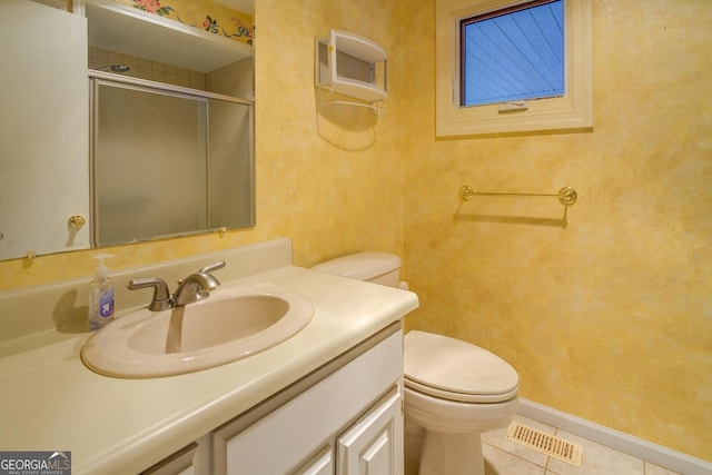 bathroom with vanity, a shower with door, tile patterned floors, and toilet