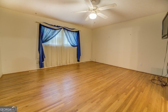 empty room featuring ceiling fan and light hardwood / wood-style floors