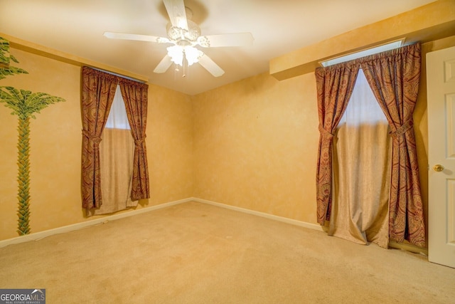 empty room with carpet and ceiling fan