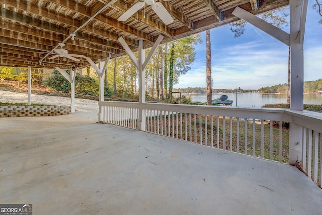 view of patio with ceiling fan and a water view