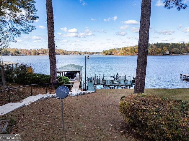 view of dock featuring a gazebo and a water view