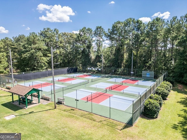 view of tennis court featuring a lawn