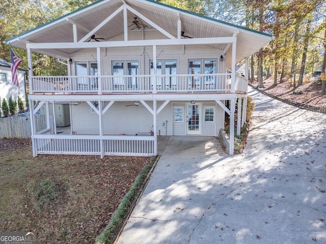 view of front facade featuring french doors, ceiling fan, and covered porch