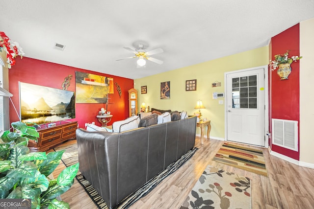 living room with hardwood / wood-style floors and ceiling fan