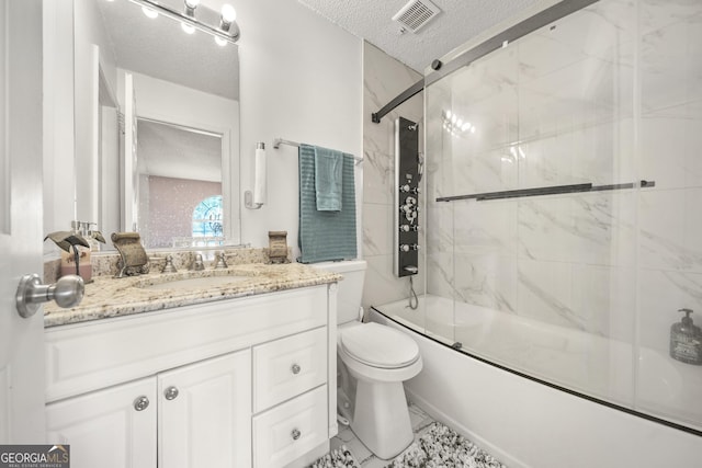 full bathroom with bath / shower combo with glass door, vanity, a textured ceiling, and toilet