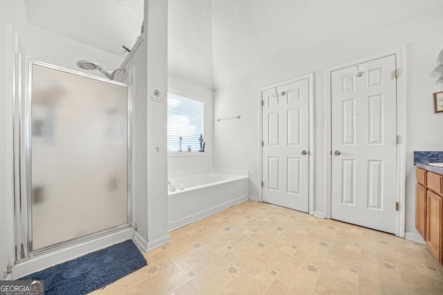 bathroom featuring vanity, shower with separate bathtub, and a textured ceiling