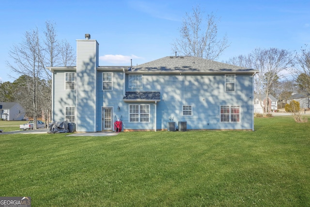 back of house featuring a yard and a patio area