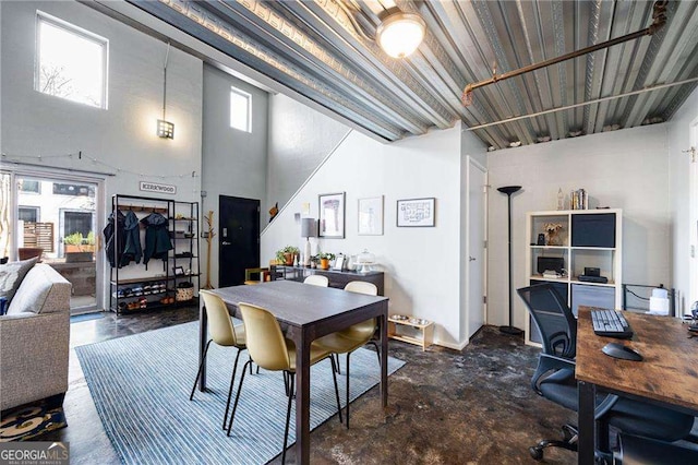 dining space with a towering ceiling