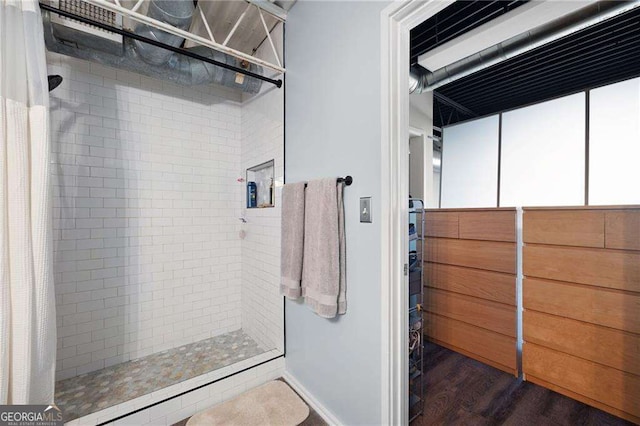 bathroom with hardwood / wood-style floors and curtained shower